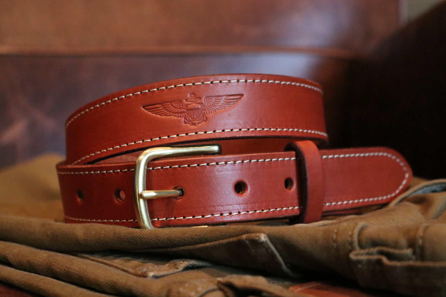 Handcrafted full-grain leather belt featuring debossed Naval Aviator insignia.