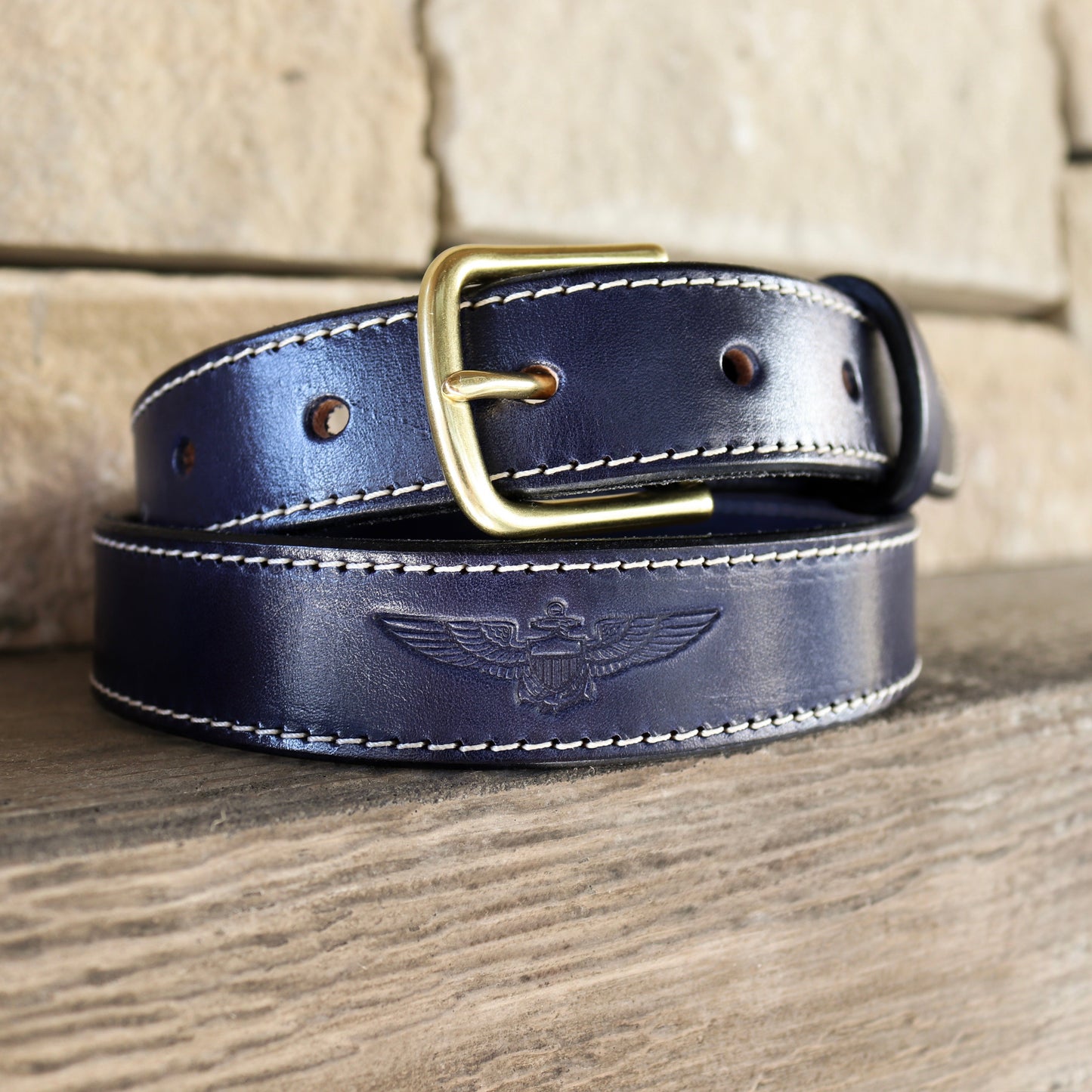 Blue leather belt with brass hardware debossed with naval aviator (pilot) wings