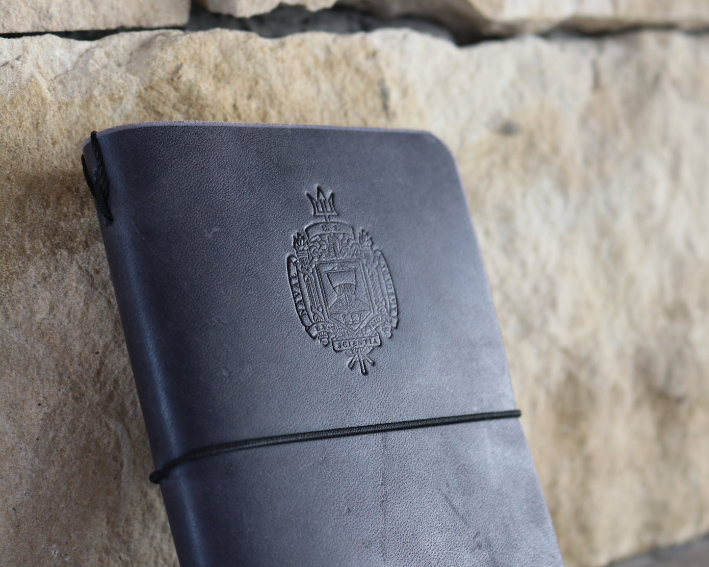 Navy blue field notes journal debossed with Naval Academy Crest