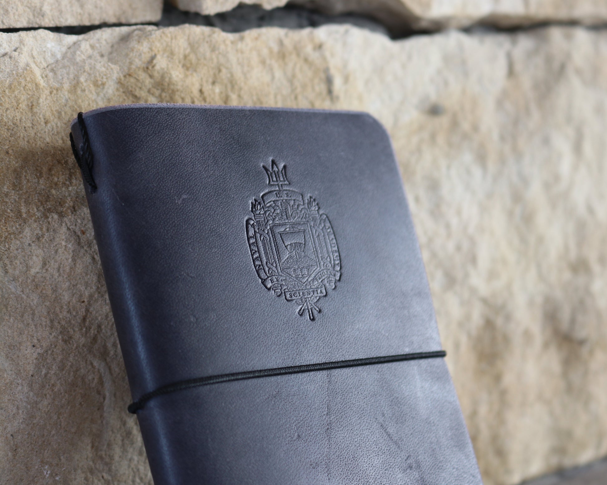 Navy blue field notes journal debossed with Naval Academy Crest