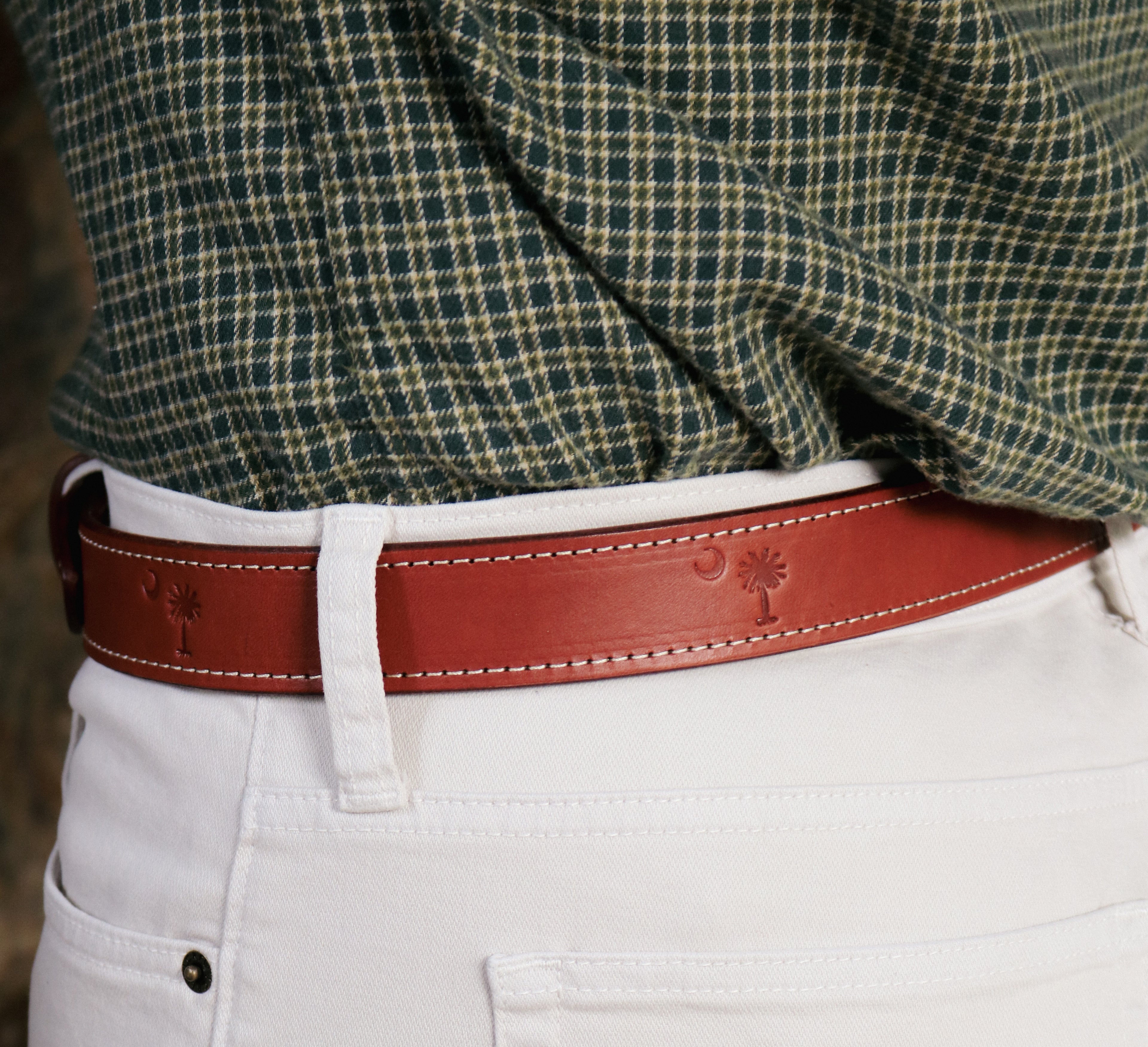 Brown full-grain leather belt handcrafted in Matthews, NC and debossed with the South Carolina state flag emblem